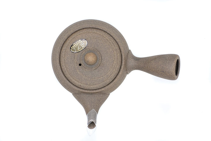 Top view of a light-brown clay Japanese tea pot (kyusu) made in Tokoname, with a side handle.