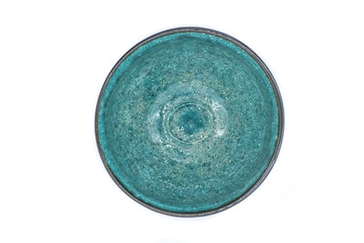 Inside of a matcha bowl, showing its vibrant and glazed turquoise color.