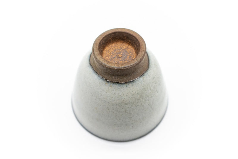 The underside of a small and delicate grey handmade cup for drinking gyokuro green tea, made in Koishiwara, Fukuoka, Japan by Onimaru the Second